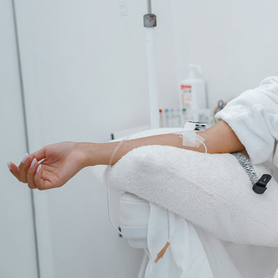 Woman's arm in relaxing room getting an IV infusion